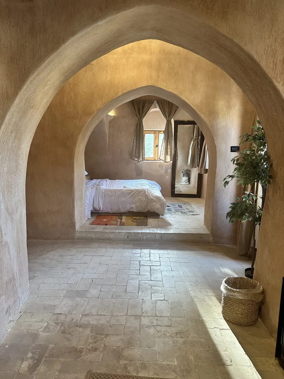 A peaceful Egyptian room seen through a series of warm stone arches