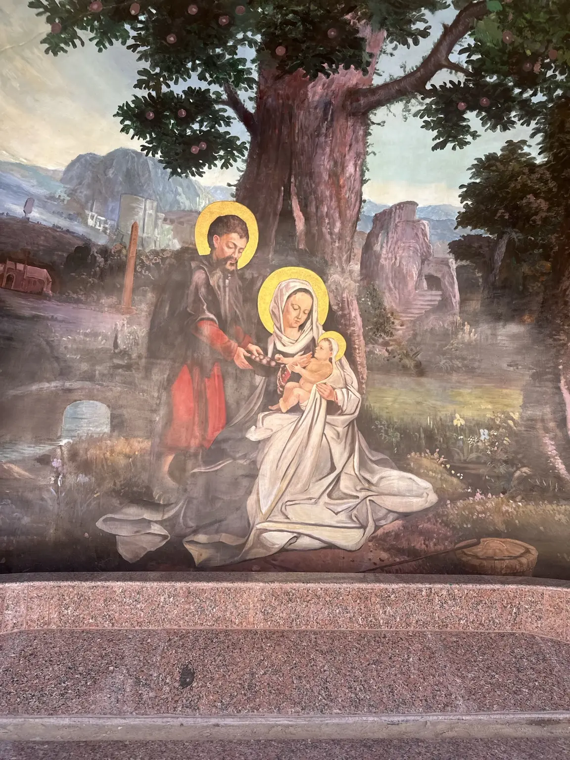 A painted scene of the Holy Family resting beneath a tree in Egypt